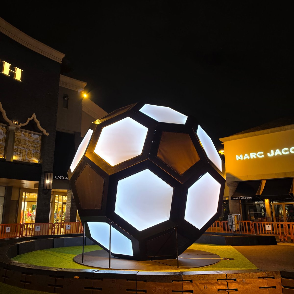 Completed 20-foot illuminated walk-through soccer ball glowing at night at The Citadel Outlets