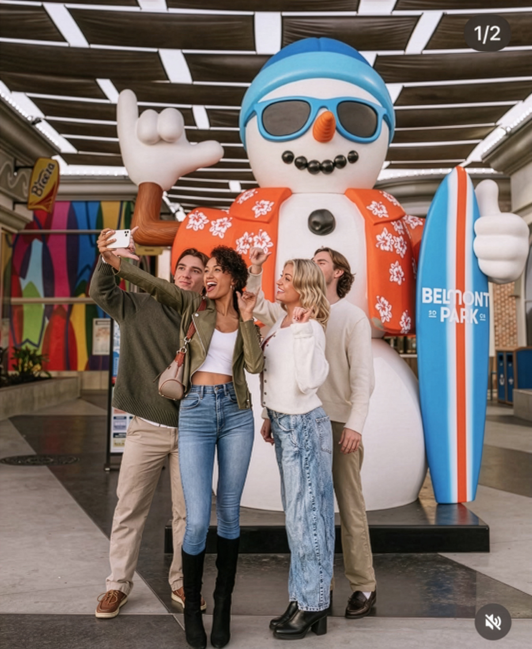 Visitors taking a photo with a surf snowman display